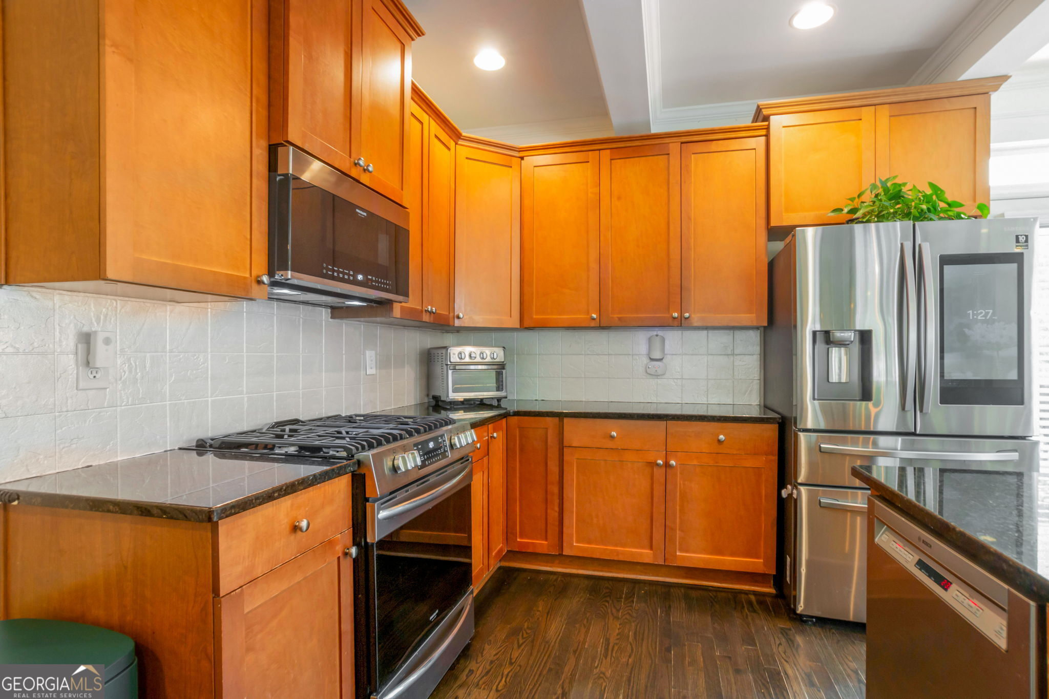 2524 Kickerillo Way Southeast Atlanta, GA 30316 - Photo 9 of 50 a kitchen with stainless steel appliances granite countertop a stove a sink and a refrigerator