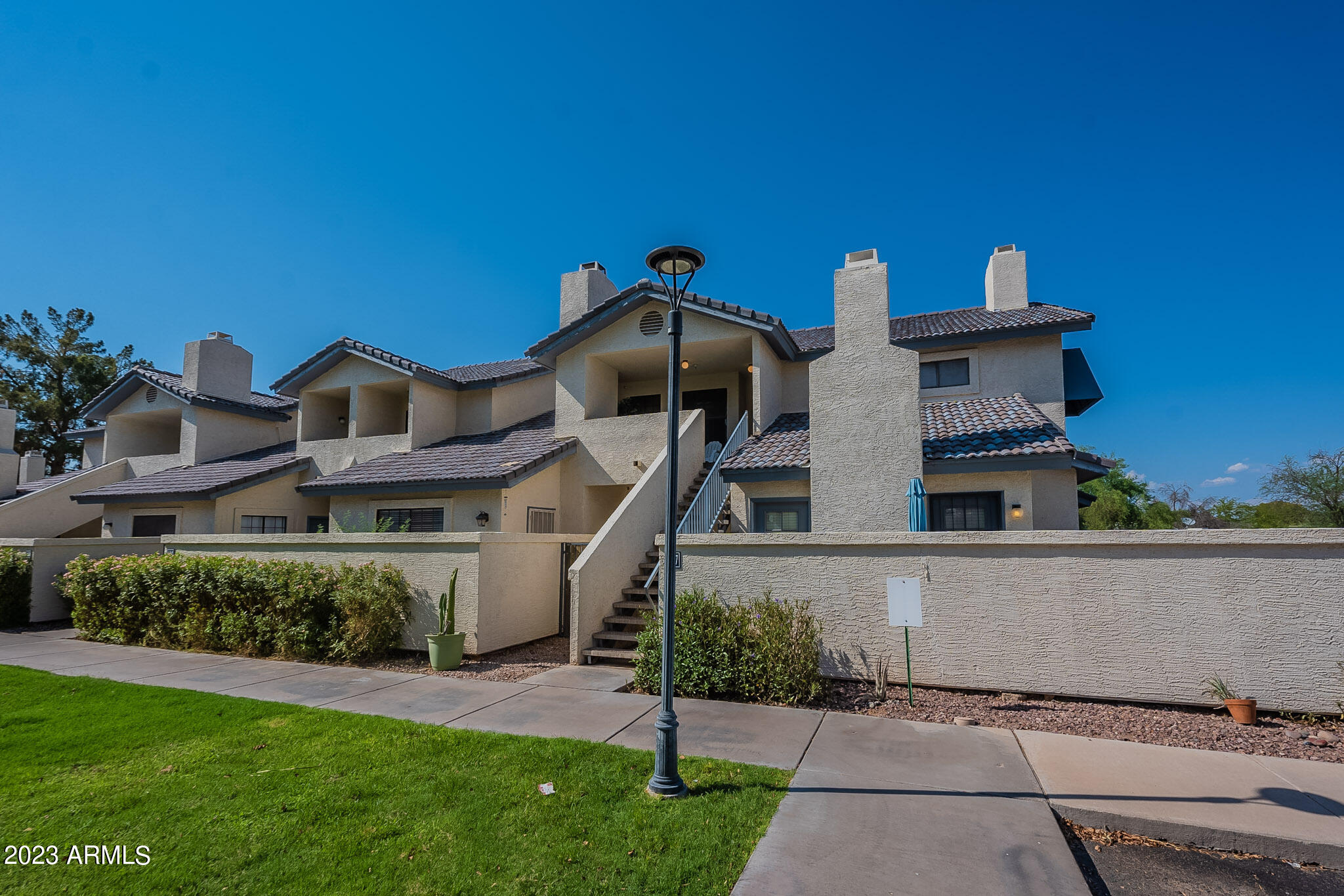 1222 West Baseline Road, Unit 237 Tempe, AZ 85283 - Photo 3 of 41 a front view of a house with a yard