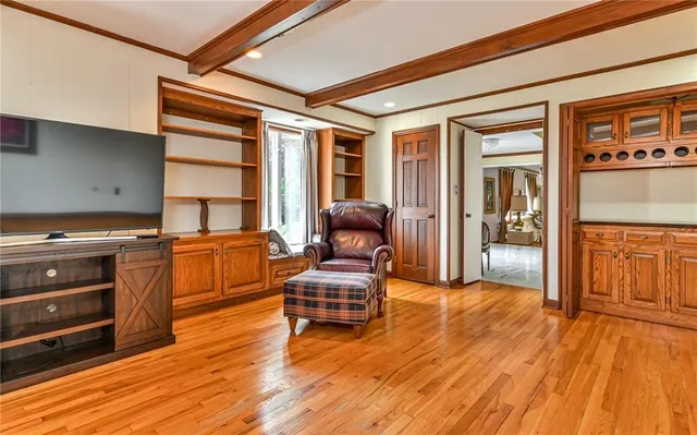 a living room with furniture and wooden floors