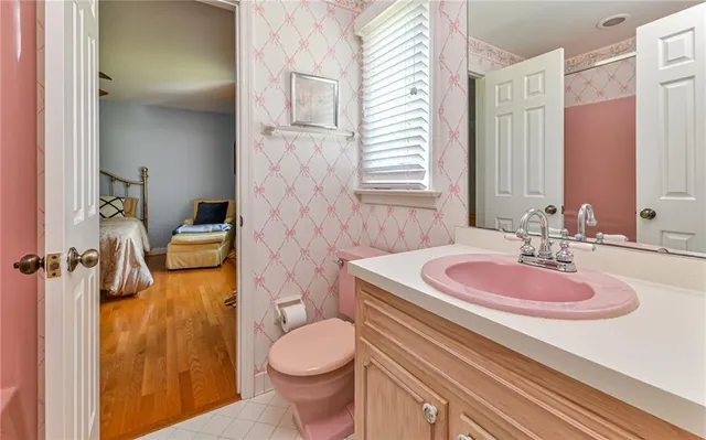 a bathroom with a sink a toilet and a mirror