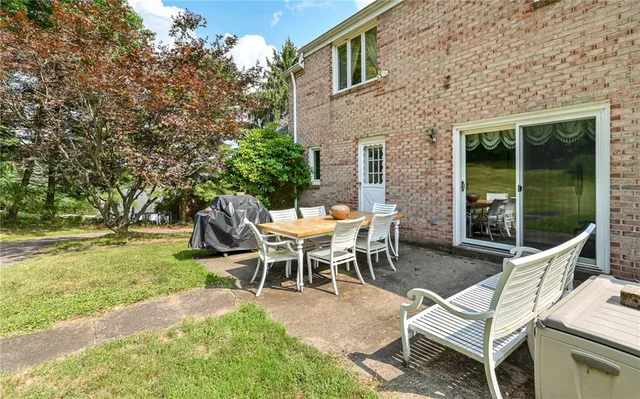 a view of a patio with a table and chairs