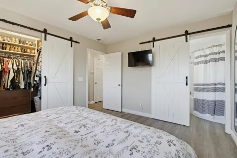 a bedroom with a bed and a flat screen tv