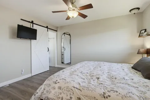 a bedroom with a bed and a flat screen tv