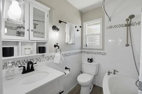 a bathroom with a sink toilet tub and shower