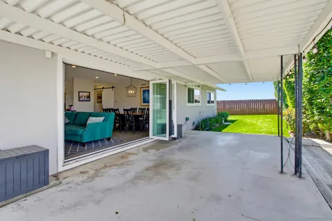 a view of an empty room with wooden floor and fence