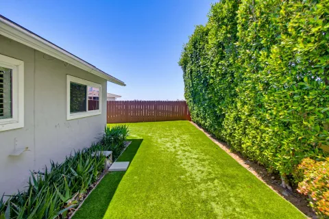 a view of a house with backyard sitting area and garden