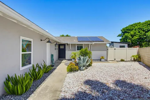 a view of a house with a yard and sitting area