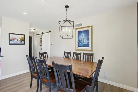 a view of a dining room with furniture wooden floor and chandelier