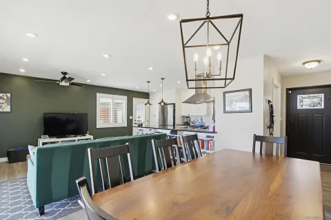 a kitchen with a table chairs refrigerator and microwave