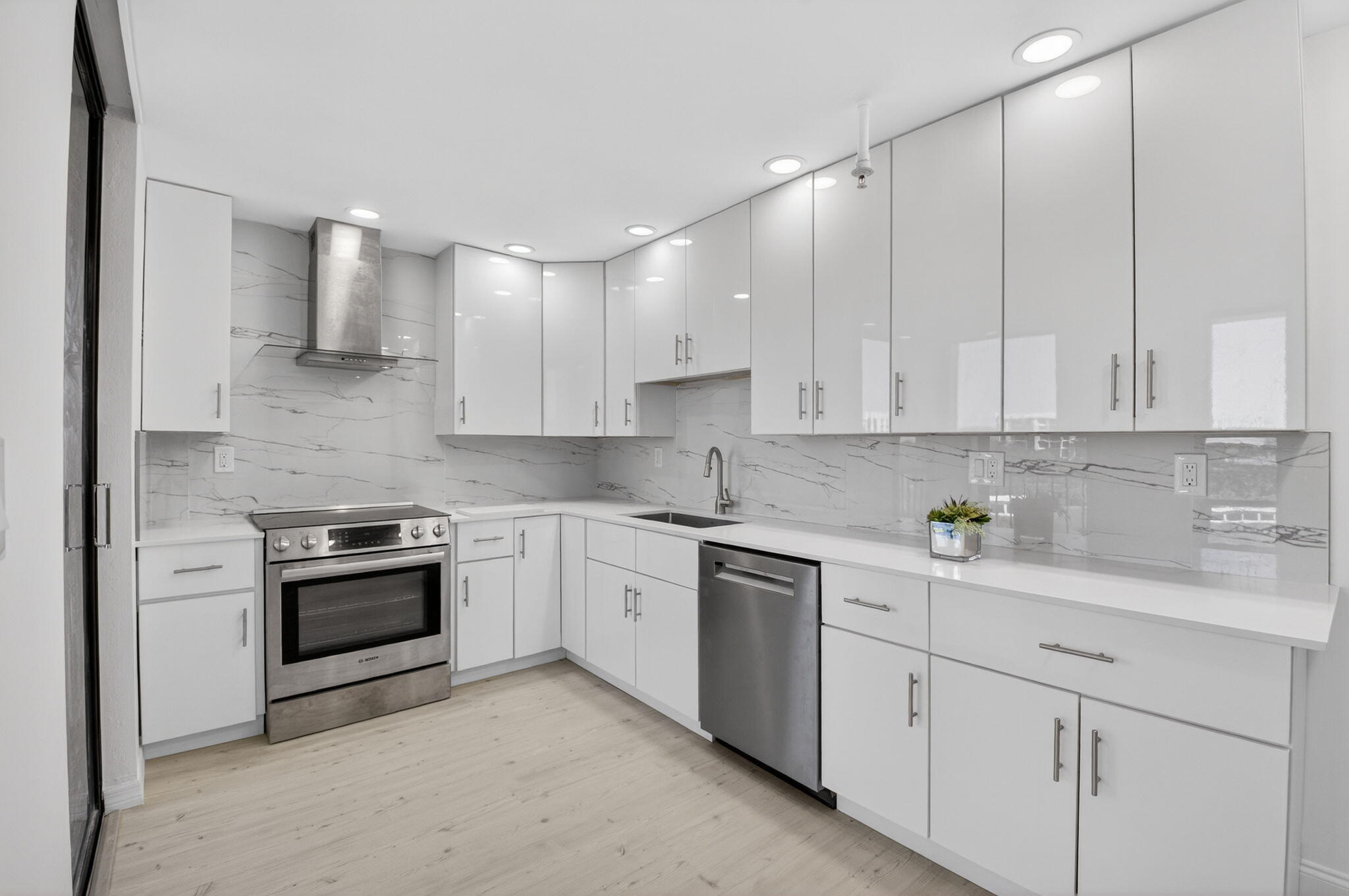 7738 Lakeside Boulevard, Unit 352 Boca Raton, FL 33434 - Photo 7 of 60 a kitchen with cabinets stainless steel appliances and sink