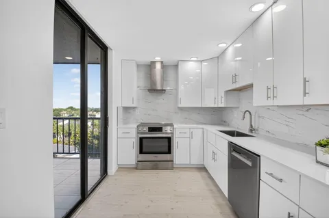 a kitchen with white cabinets and white appliances