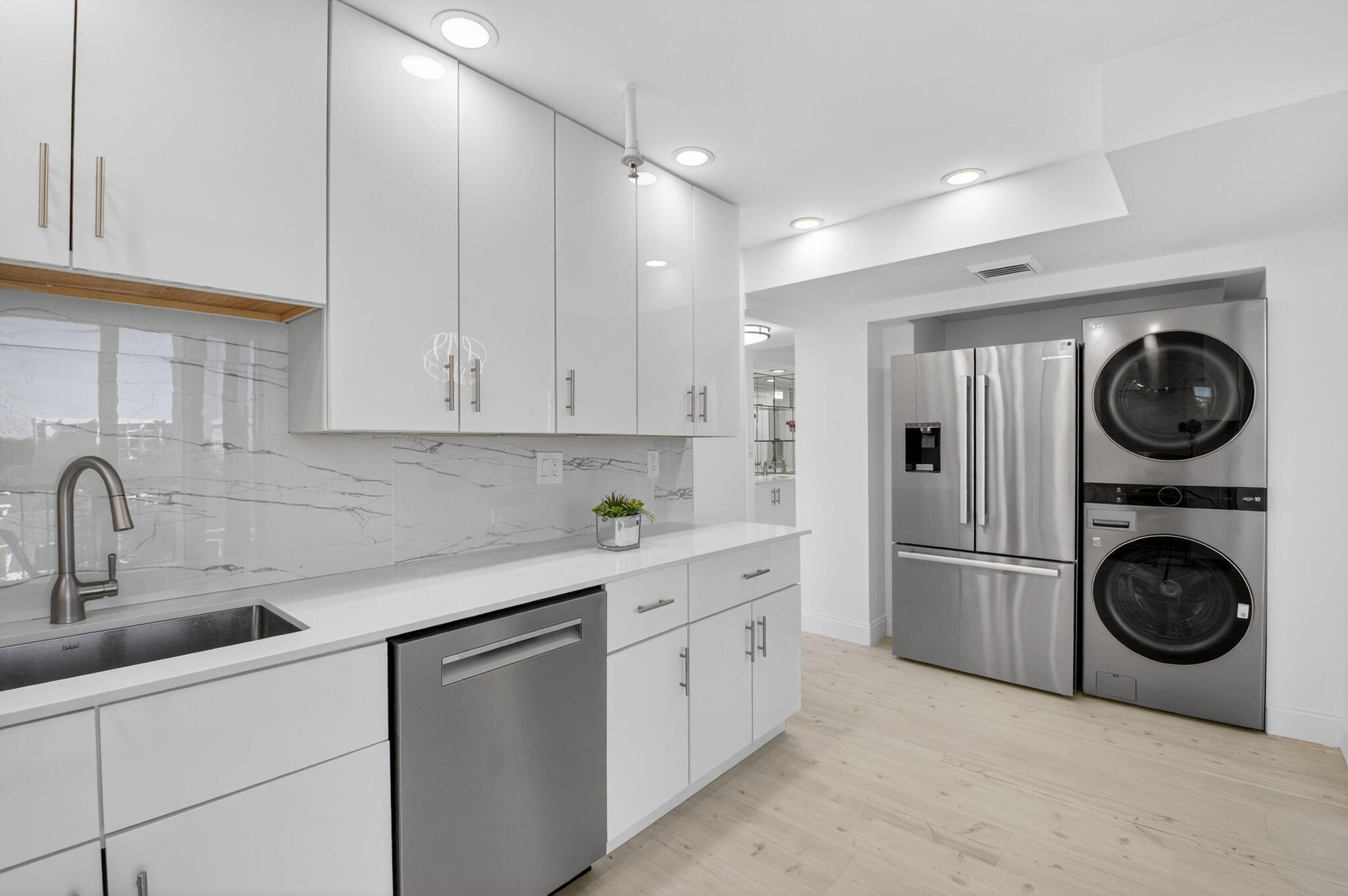 7738 Lakeside Boulevard, Unit 352 Boca Raton, FL 33434 - Photo 9 of 60 a kitchen with white cabinets and white appliances