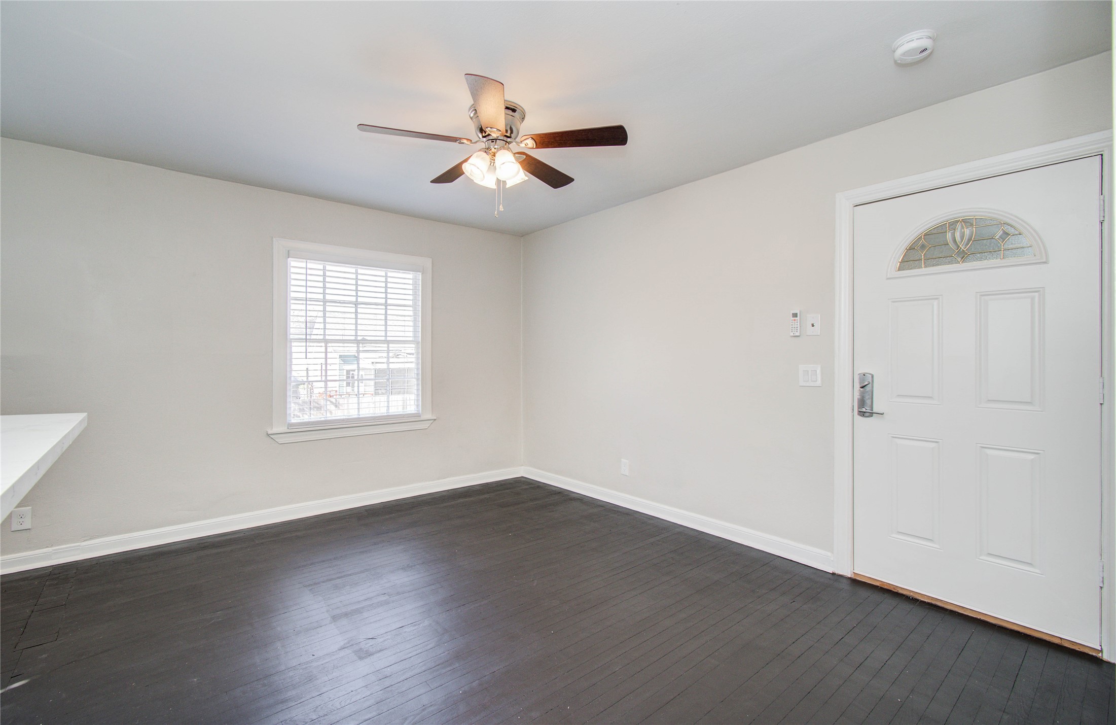 710 Hemphill Street, Unit 2 Houston, TX 77007 - Photo 2 of 21 an empty room with wooden floor fan and windows