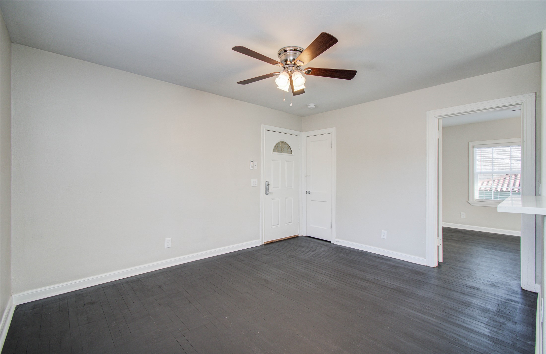 710 Hemphill Street, Unit 2 Houston, TX 77007 - Photo 3 of 21 an empty room with wooden floor and windows