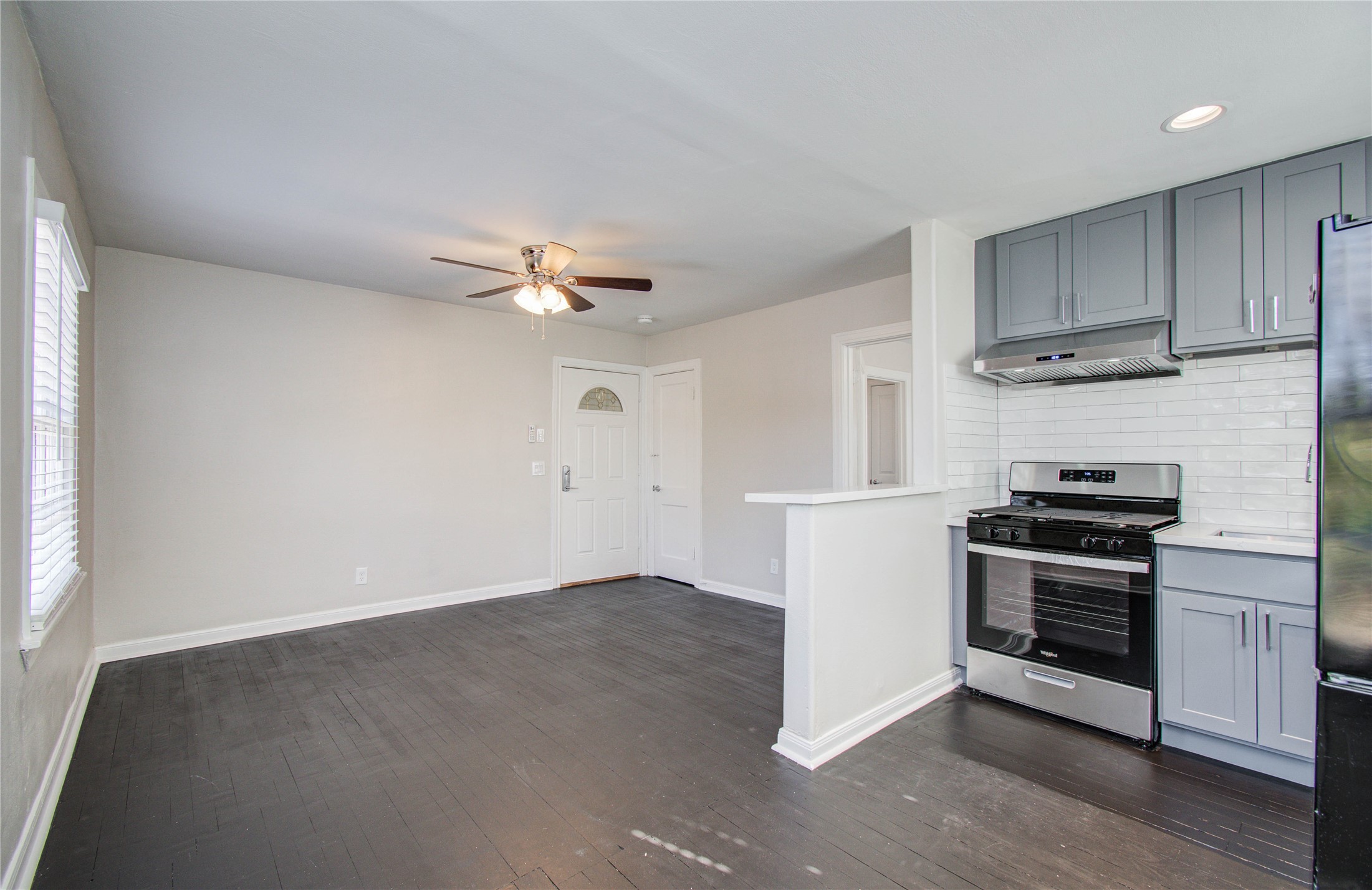 710 Hemphill Street, Unit 2 Houston, TX 77007 - Photo 7 of 21 a kitchen with cabinets stainless steel appliances and a window