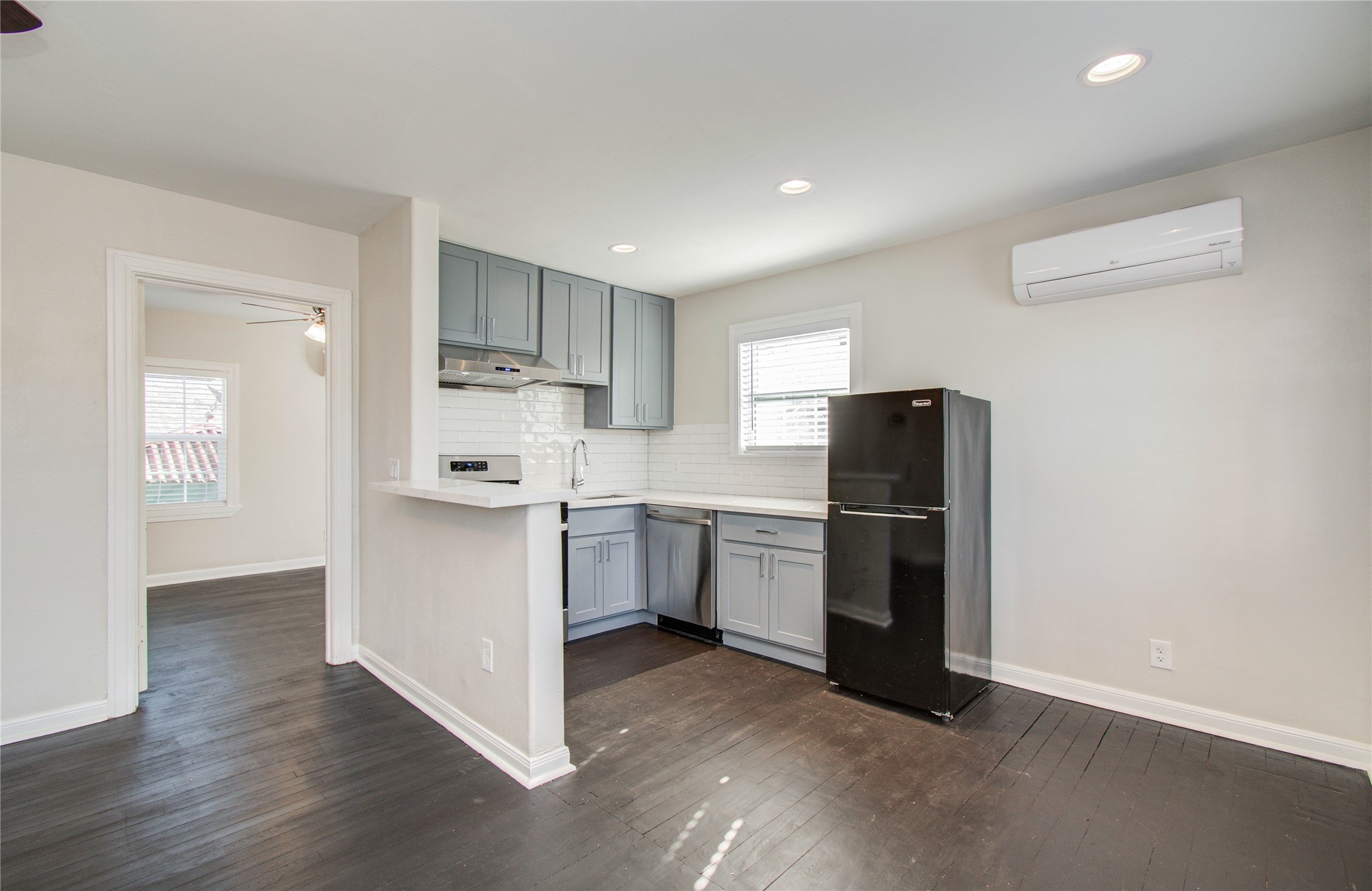 710 Hemphill Street, Unit 2 Houston, TX 77007 - Photo 9 of 21 a kitchen with a refrigerator and white cabinets