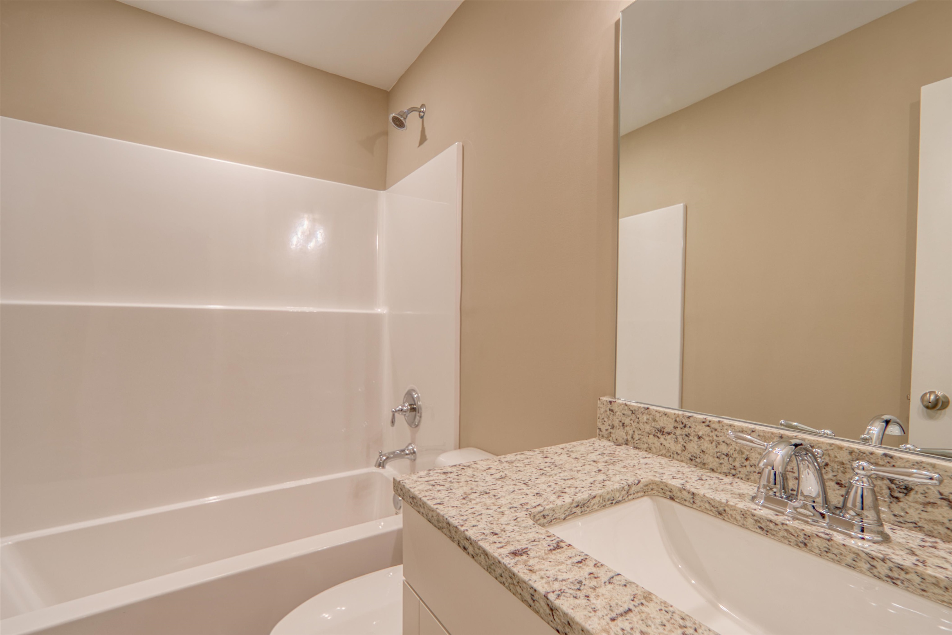 107 Stone Brook Cove Ripley, TN 38063 - Photo 13 of 31 a bathroom with a granite countertop sink and a mirror