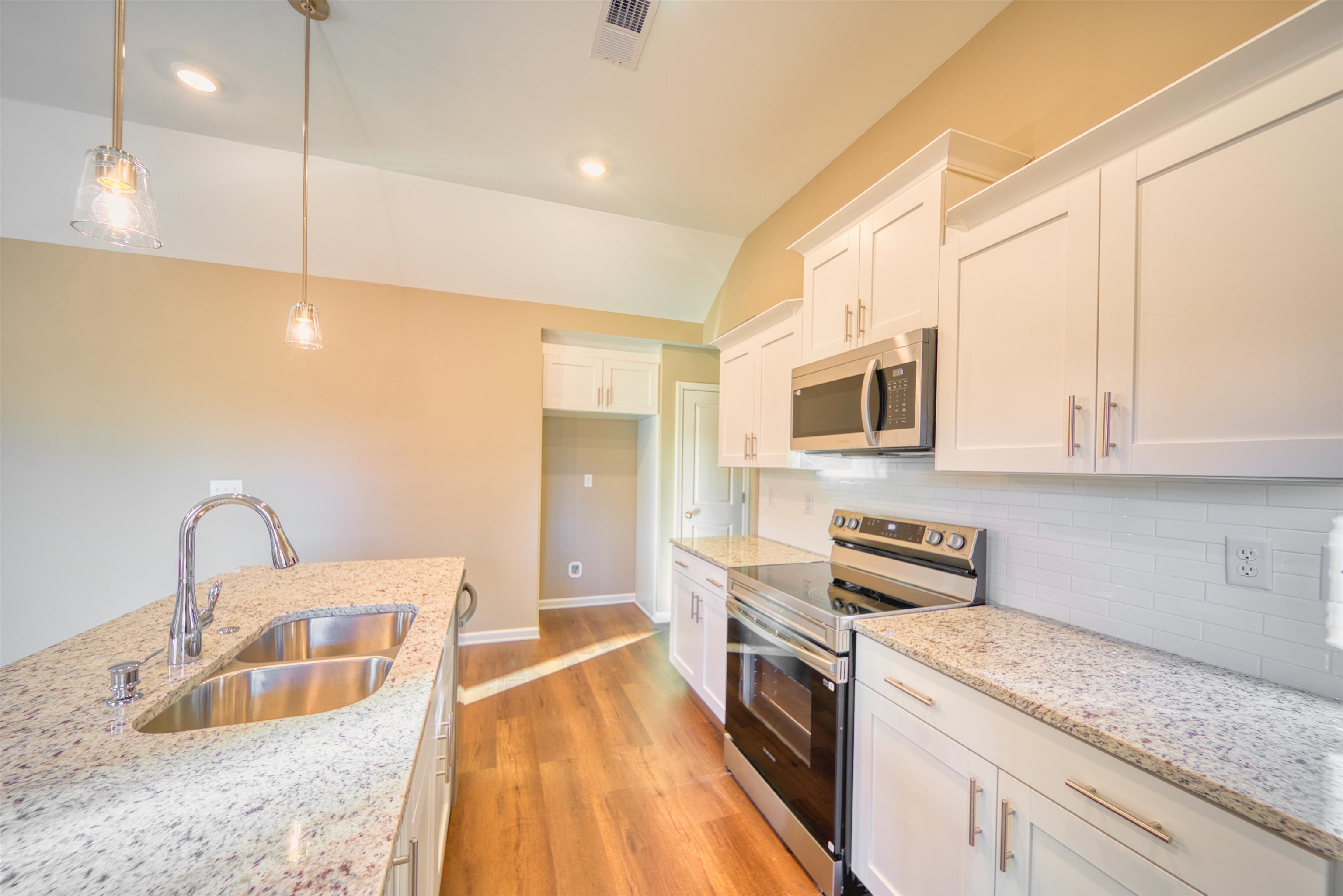 107 Stone Brook Cove Ripley, TN 38063 - Photo 21 of 31 a kitchen with stainless steel appliances granite countertop a sink a stove and a microwave oven with cabinets