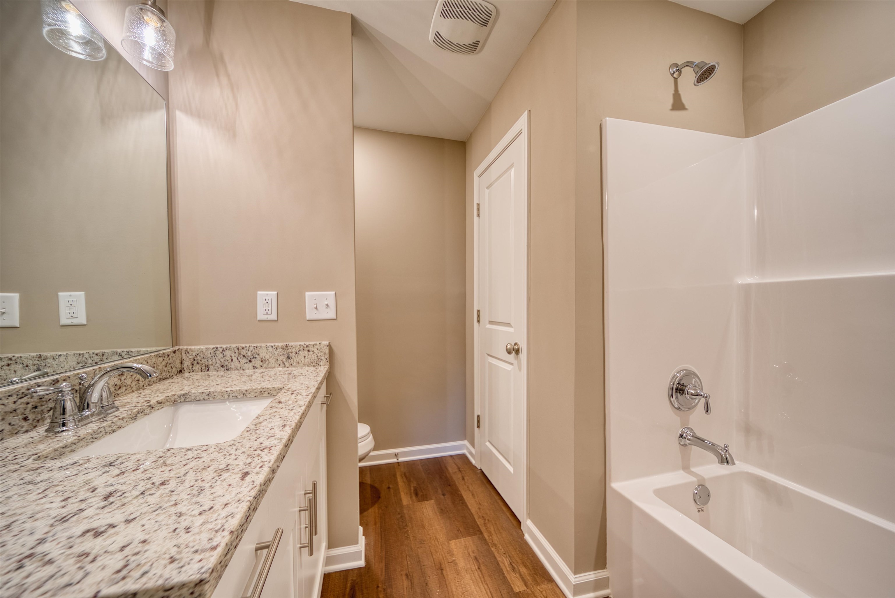 107 Stone Brook Cove Ripley, TN 38063 - Photo 26 of 31 a bathroom with a granite countertop sink and a bathtub