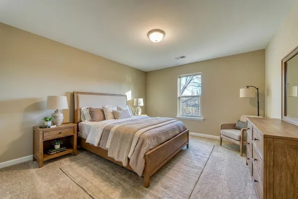 a bedroom with a bed and window