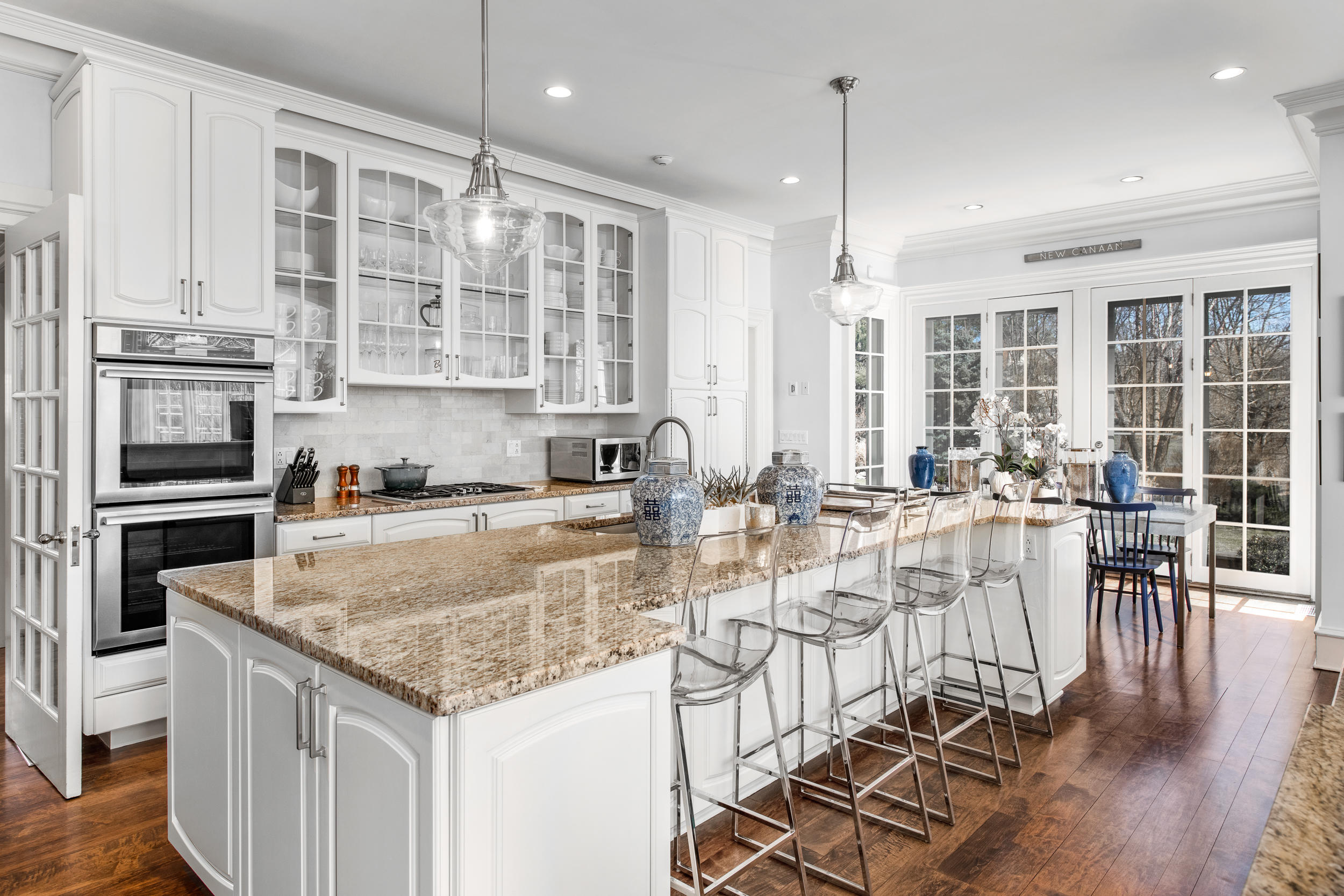 235 Brushy Ridge Road New Canaan, CT 06840 - Photo 17 of 28 a view of a kitchen with kitchen island granite countertop a large window and stainless steel appliances