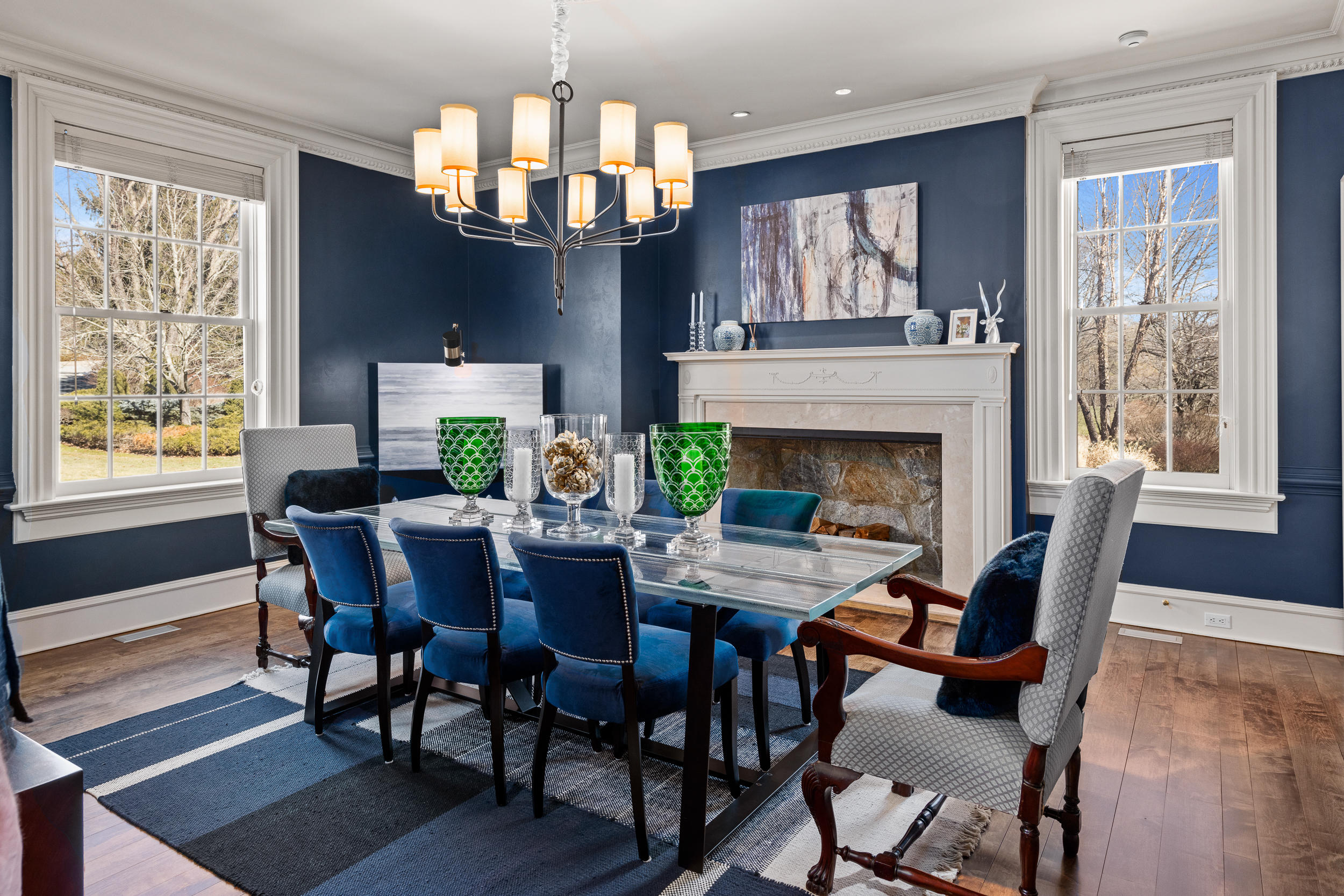 235 Brushy Ridge Road New Canaan, CT 06840 - Photo 18 of 28 a view of a dining room with furniture a chandelier and wooden floor