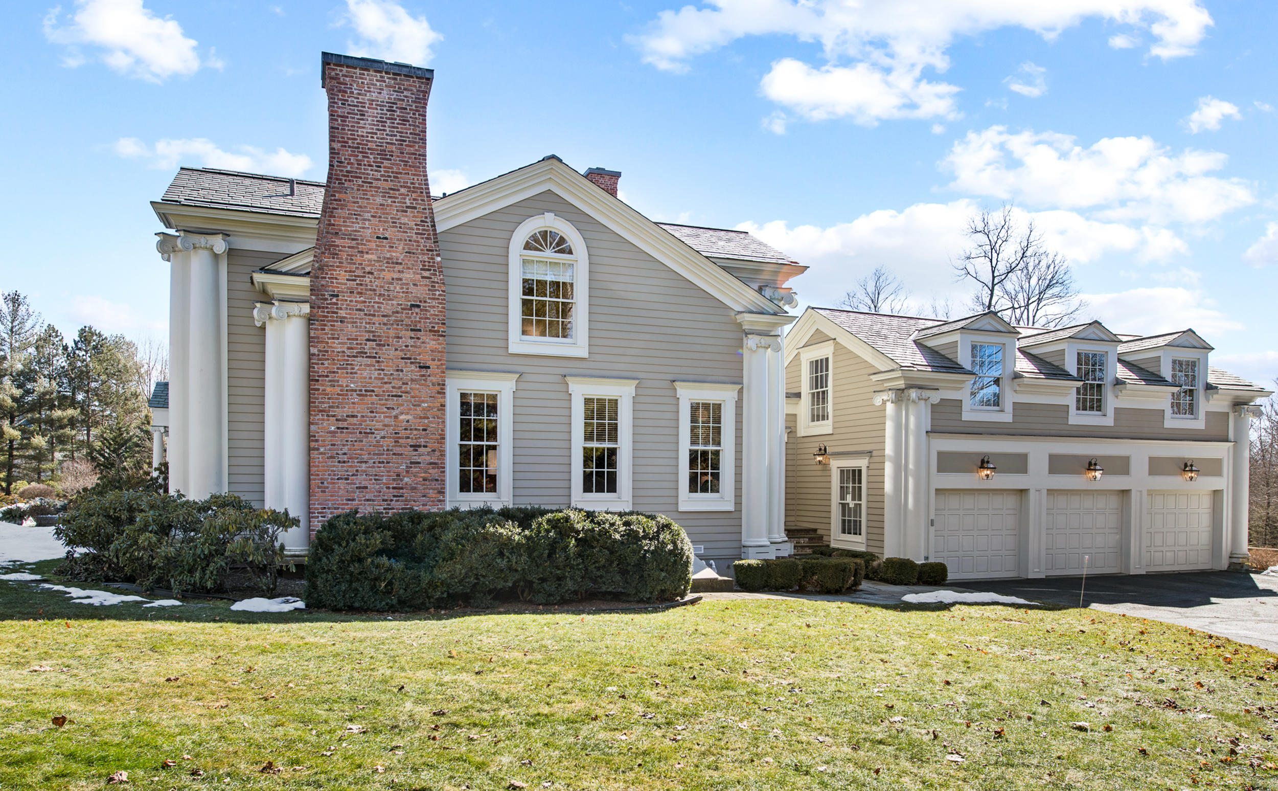 235 Brushy Ridge Road New Canaan, CT 06840 - Photo 26 of 28 a view of a house with a yard and potted plants