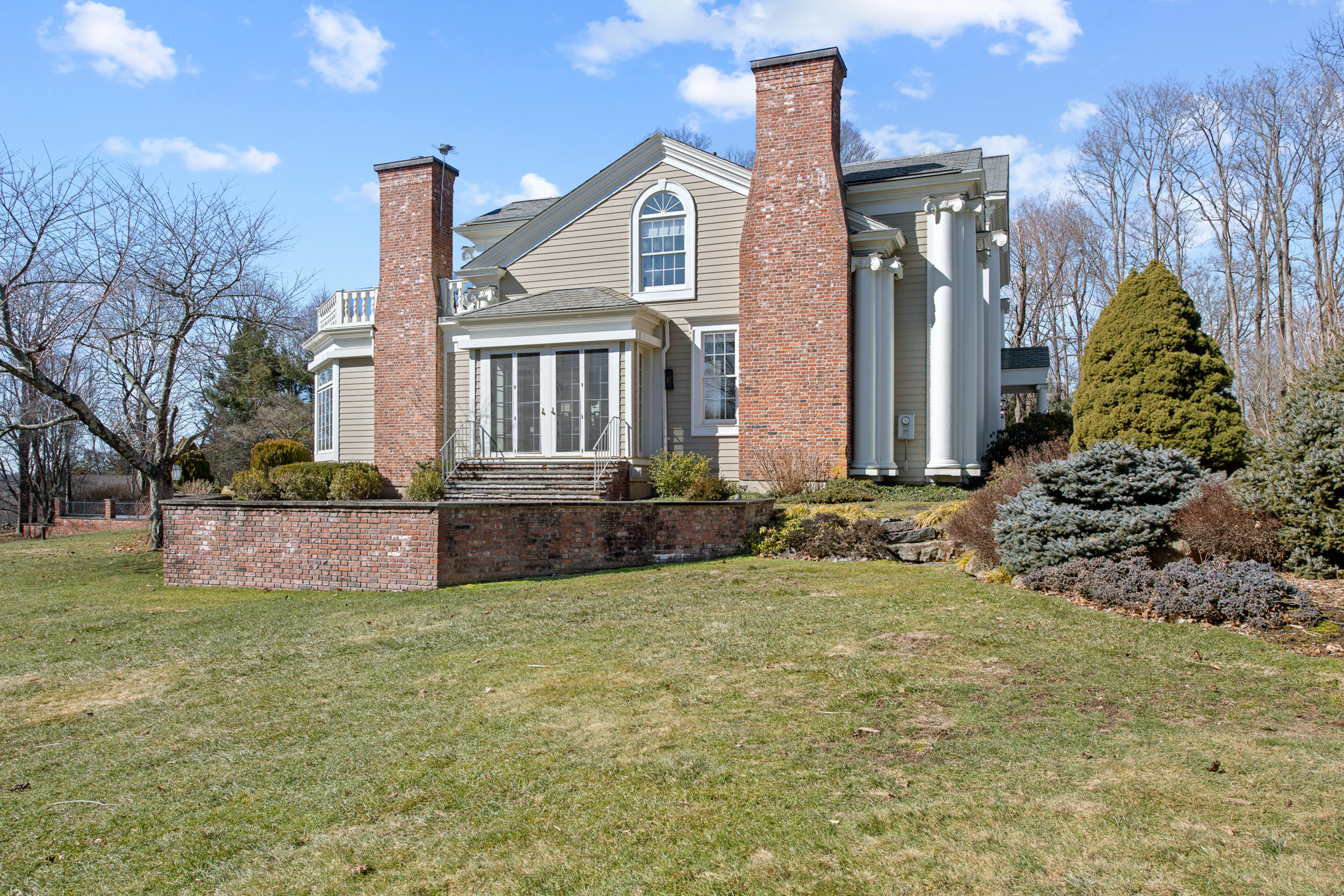 235 Brushy Ridge Road New Canaan, CT 06840 - Photo 27 of 28 a front view of a house with a yard