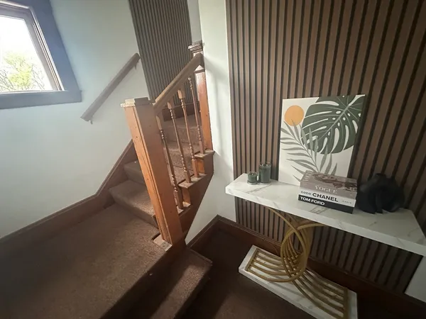 a view of entryway and hall with wooden floor