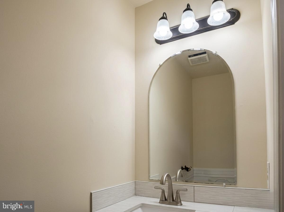3614 Fawn Spring Court Baltimore, MD 21234 - Photo 19 of 22 a bathroom with a sink and a mirror