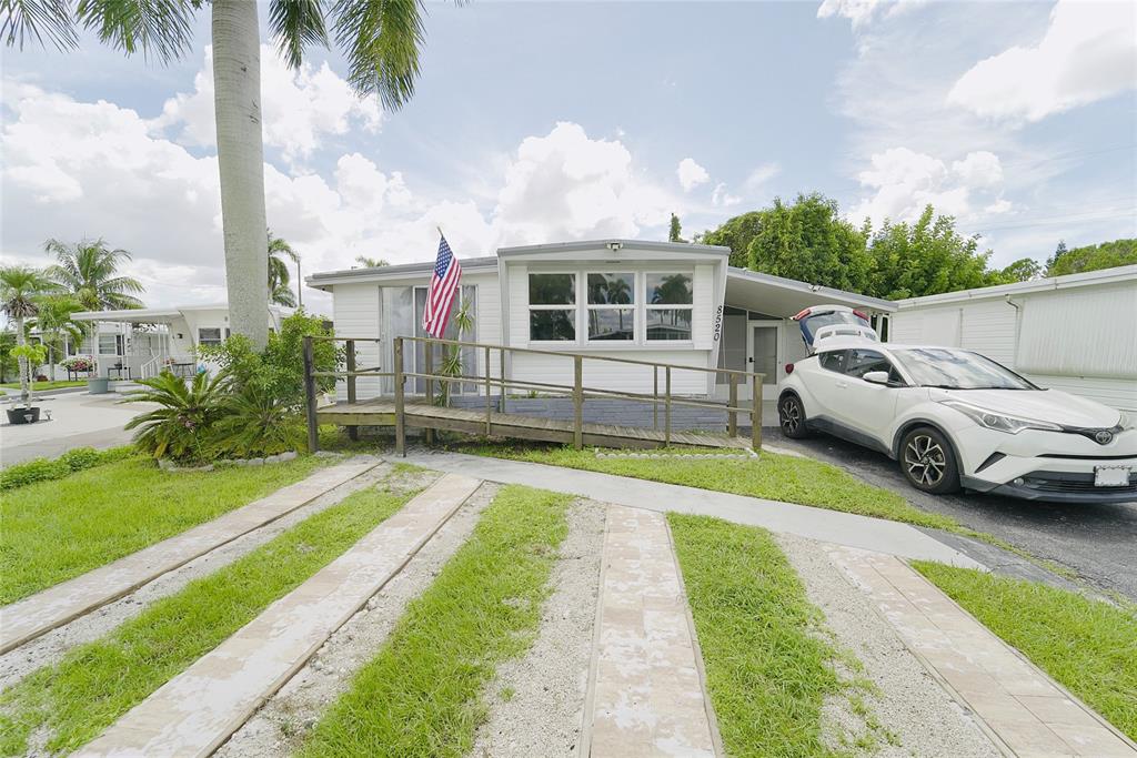 8520 Southwest 18th Court Davie, FL 33324 - Photo 11 of 48 a front view of a house with a yard table and chairs