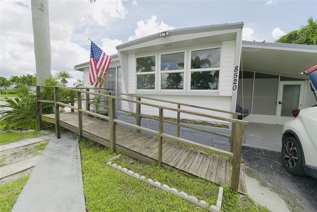 8520 Southwest 18th Court Davie, FL 33324 - Photo 2 of 48 a view of a house with a backyard and a balcony