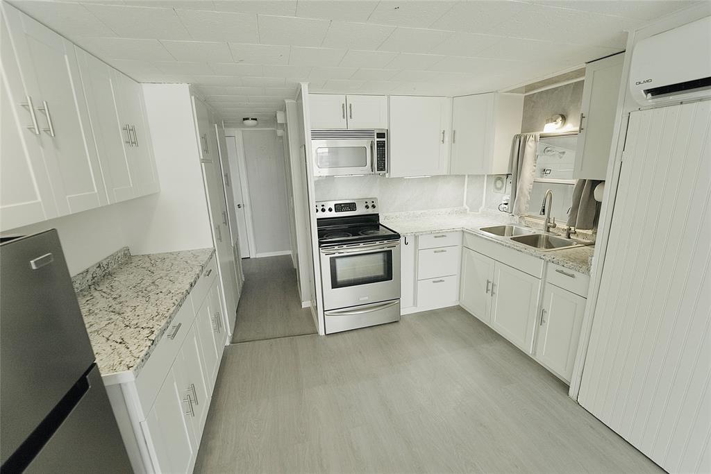 8520 Southwest 18th Court Davie, FL 33324 - Photo 23 of 48 a kitchen with white cabinets and white appliances