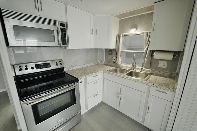 a view of a swimming pool with a yard and furniture