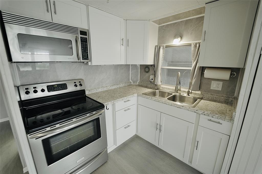 8520 Southwest 18th Court Davie, FL 33324 - Photo 37 of 48 a kitchen with appliances a sink and cabinets