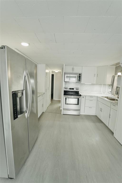 8520 Southwest 18th Court Davie, FL 33324 - Photo 46 of 48 a kitchen with stainless steel appliances and white cabinets