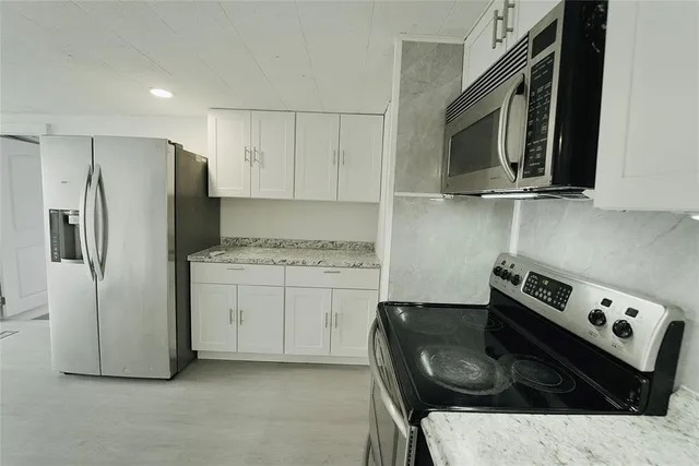 a bathroom with a toilet a sink a vanity and mirror