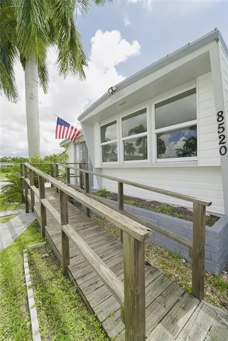 a kitchen with stainless steel appliances granite countertop a stove a sink and white cabinets