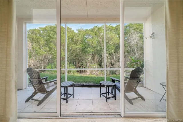 a living room with patio furniture and garden