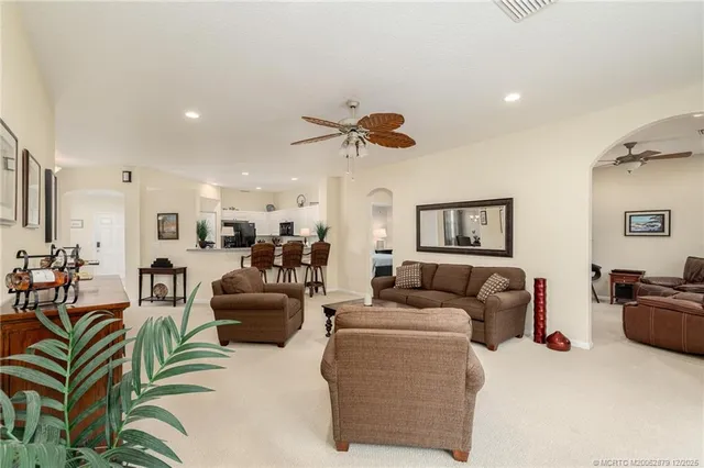 a living room with furniture ceiling fan and a rug