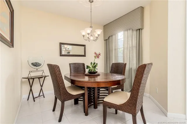 a view of a dining room with furniture and a chandelier