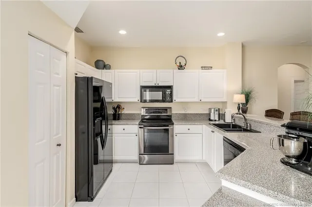 a kitchen with cabinets and stainless steel appliances