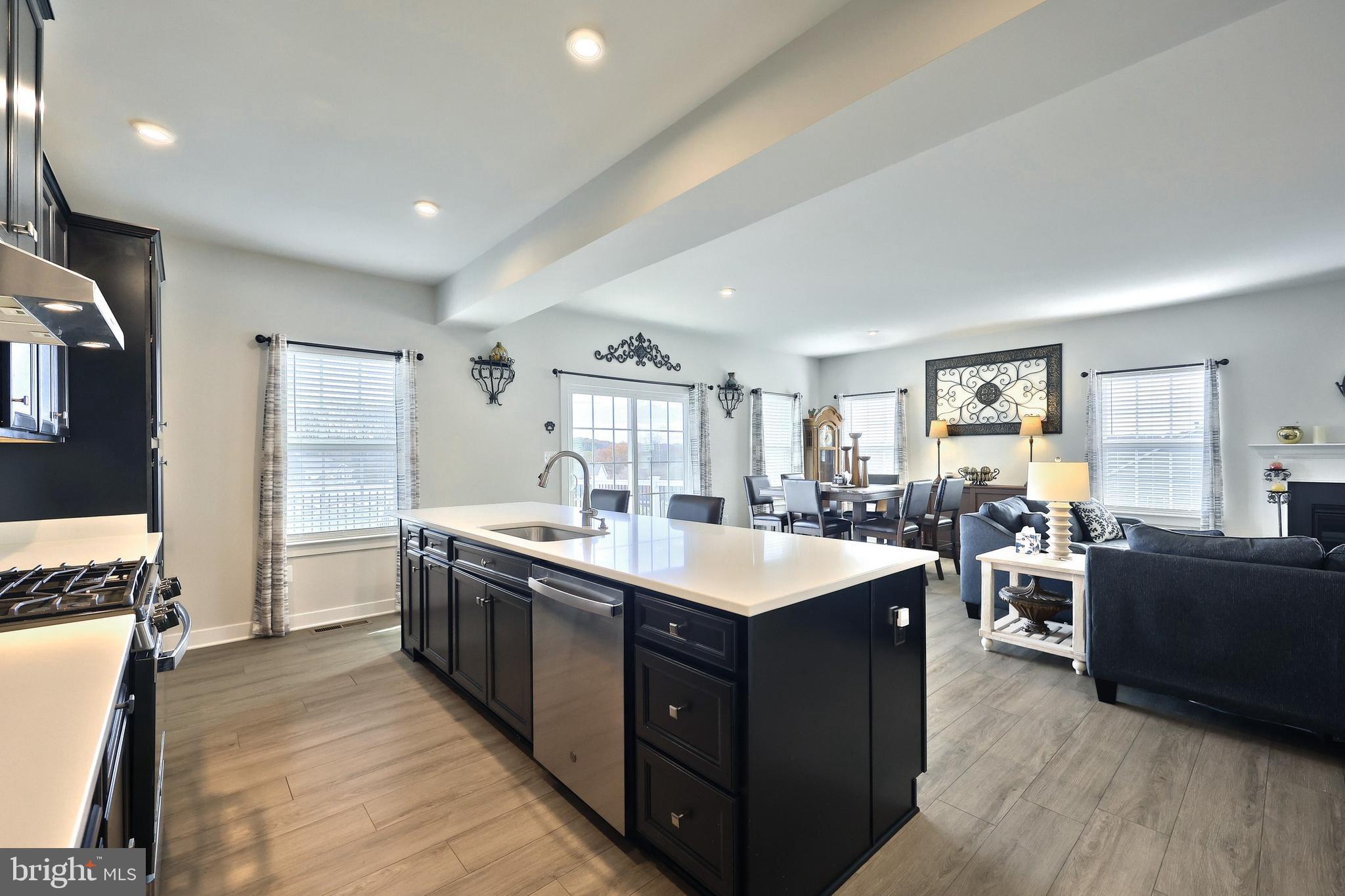 1480 Beck Mill Road Hanover, PA 17331 - Photo 71 of 71 a large kitchen with stainless steel appliances a stove a sink dishwasher and a dining table with wooden floor