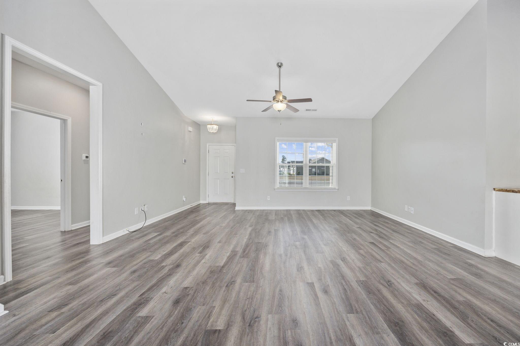 200 Obi Lane Surfside Beach, SC 29575 - Photo 8 of 40 Unfurnished living room with ceiling fan, hardwood