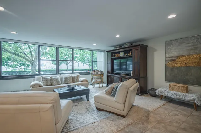 a living room with furniture and a large window