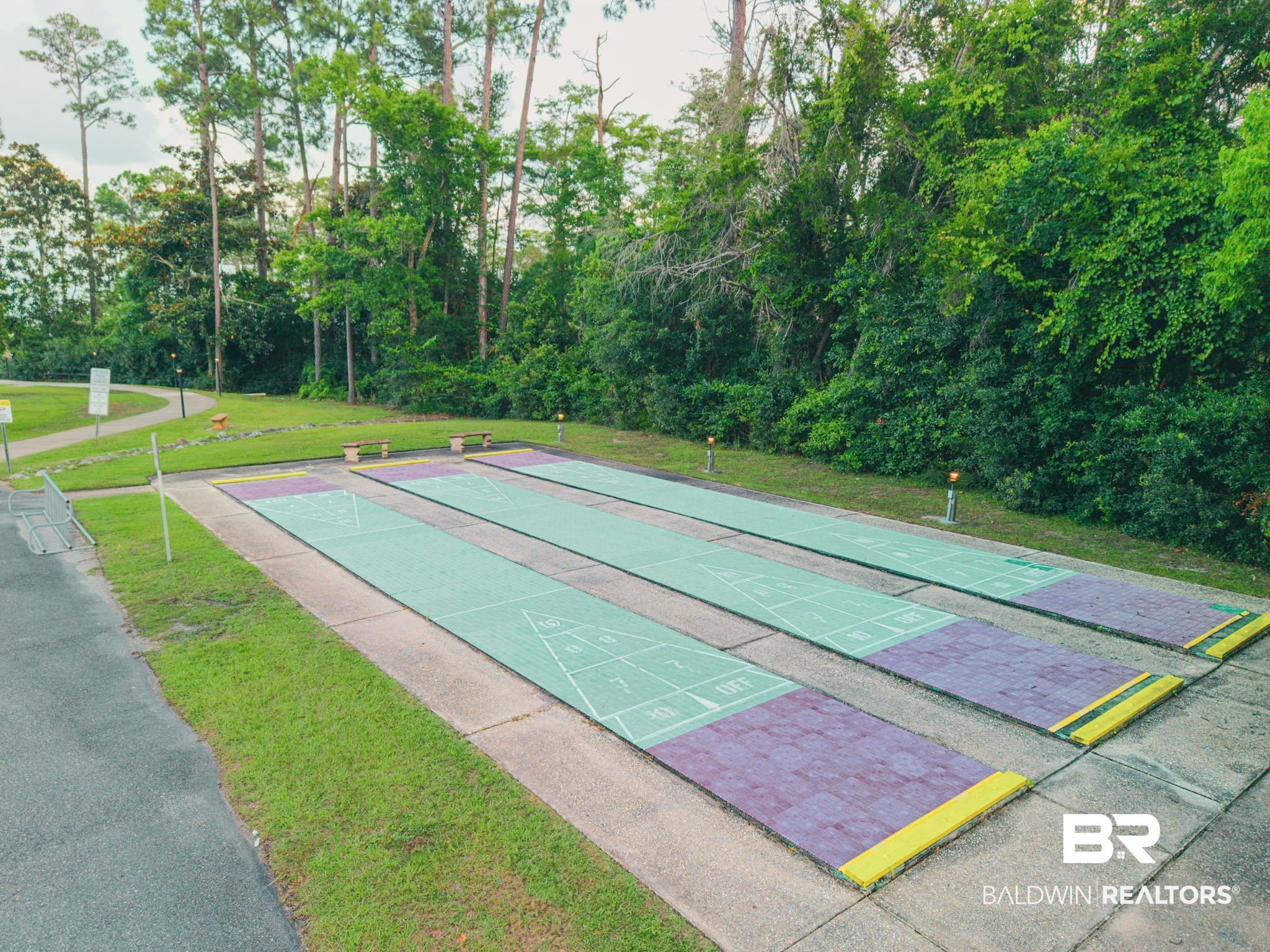1563 Valencia Drive Lillian, AL 36549 - Photo 19 of 27 View of home's community featuring a lawn and shuffleboard