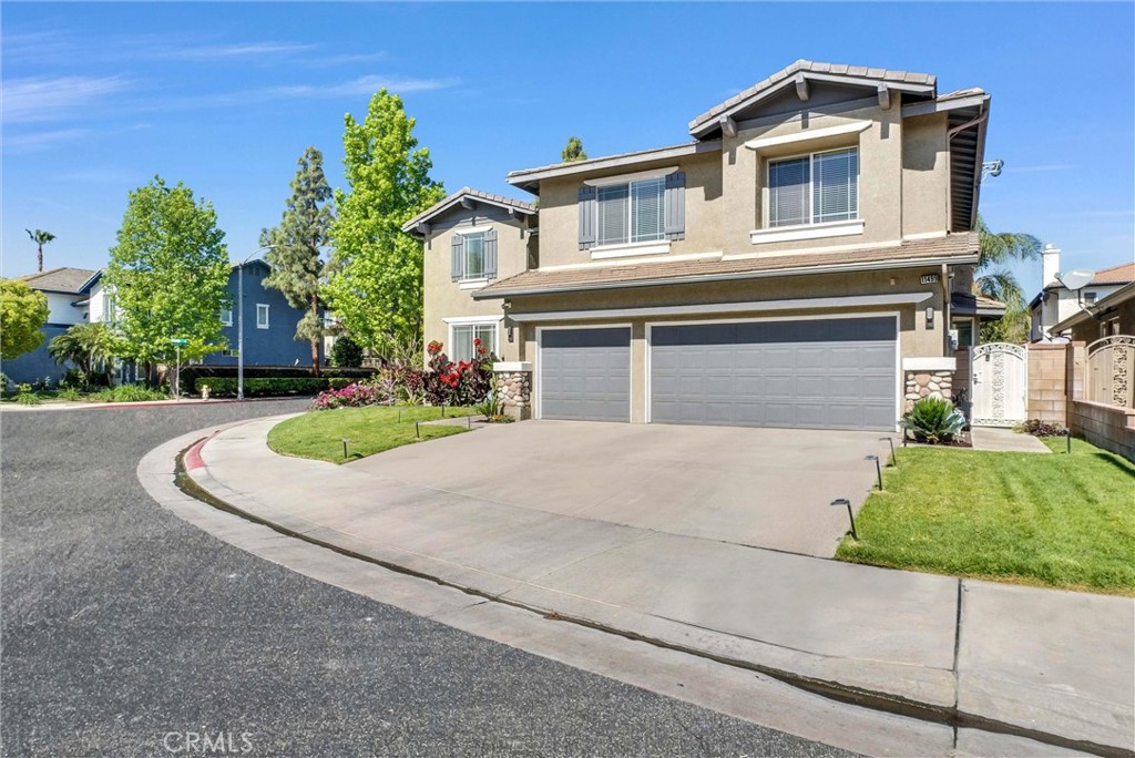 11499 Bridgeway Drive Riverside, CA 92505 - Photo 1 of 65 a front view of a house with a yard and garage