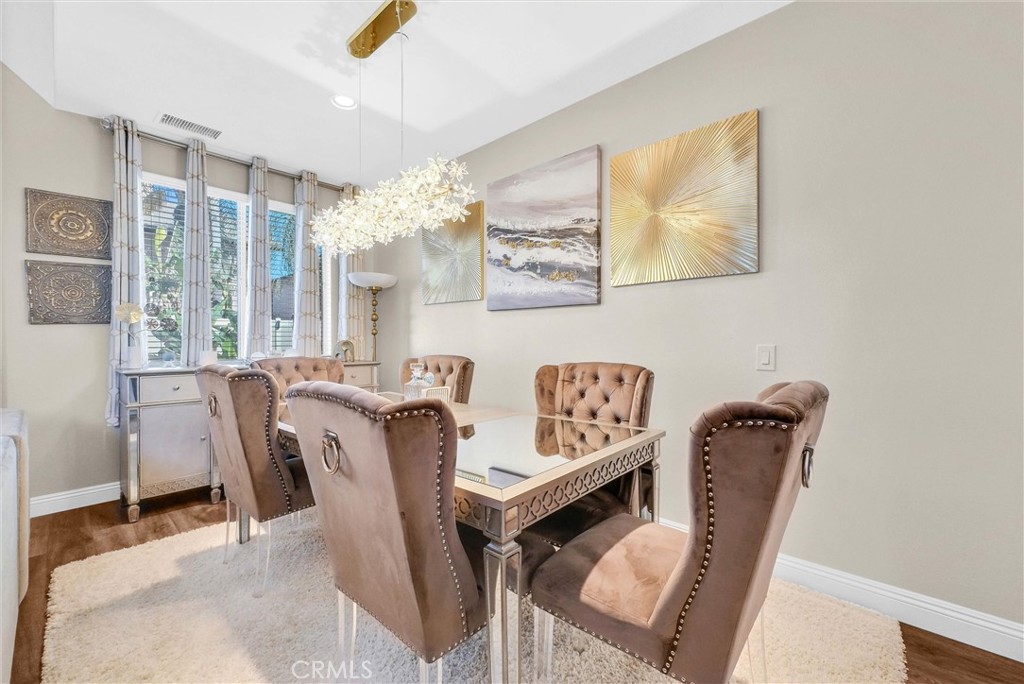 11499 Bridgeway Drive Riverside, CA 92505 - Photo 14 of 65 a view of a dining room with furniture and chandelier