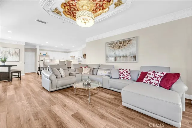 a kitchen with a dining table chairs and refrigerator