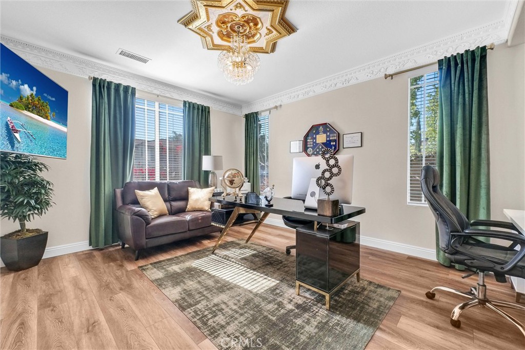 11499 Bridgeway Drive Riverside, CA 92505 - Photo 17 of 65 a living room with furniture a chandelier and a window